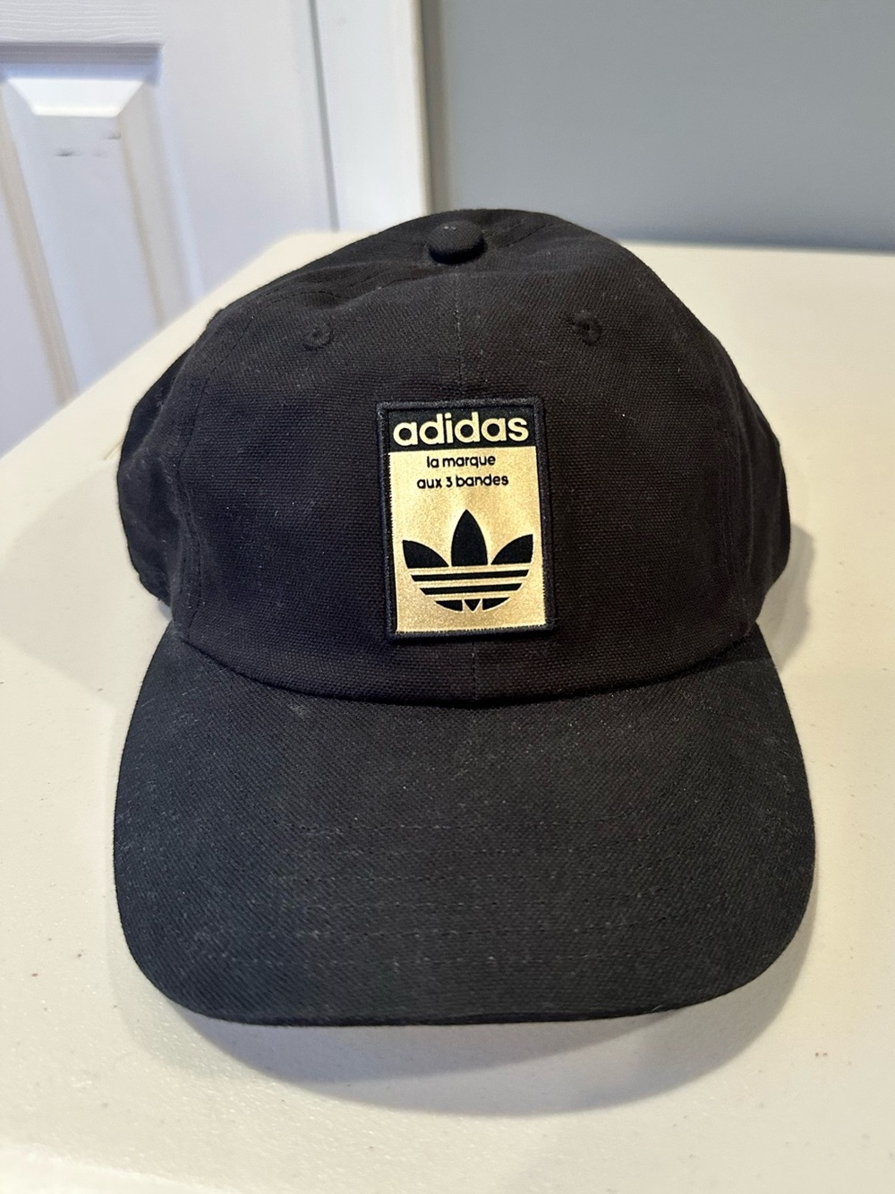 Adidas Relaxed Baseball Strapback Cap in Black/Gold (OSFM)